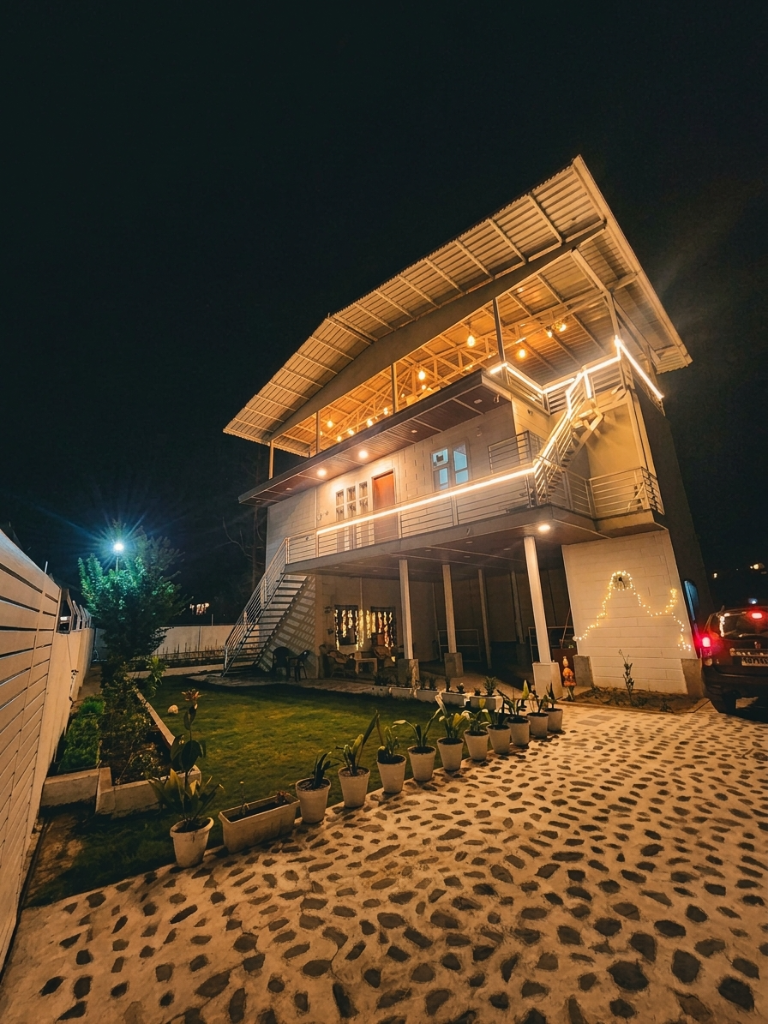 Farmhouse lit up at night with fairy lights