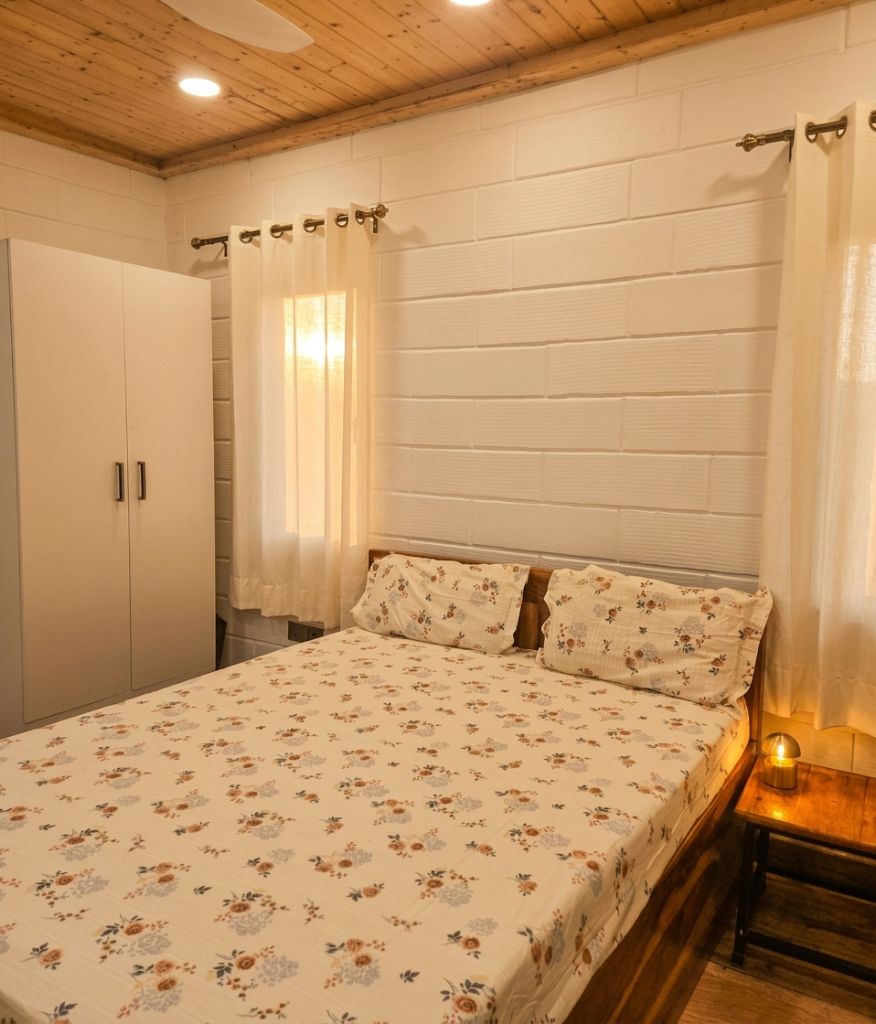 Bedroom with floral linen and pine ceiling
