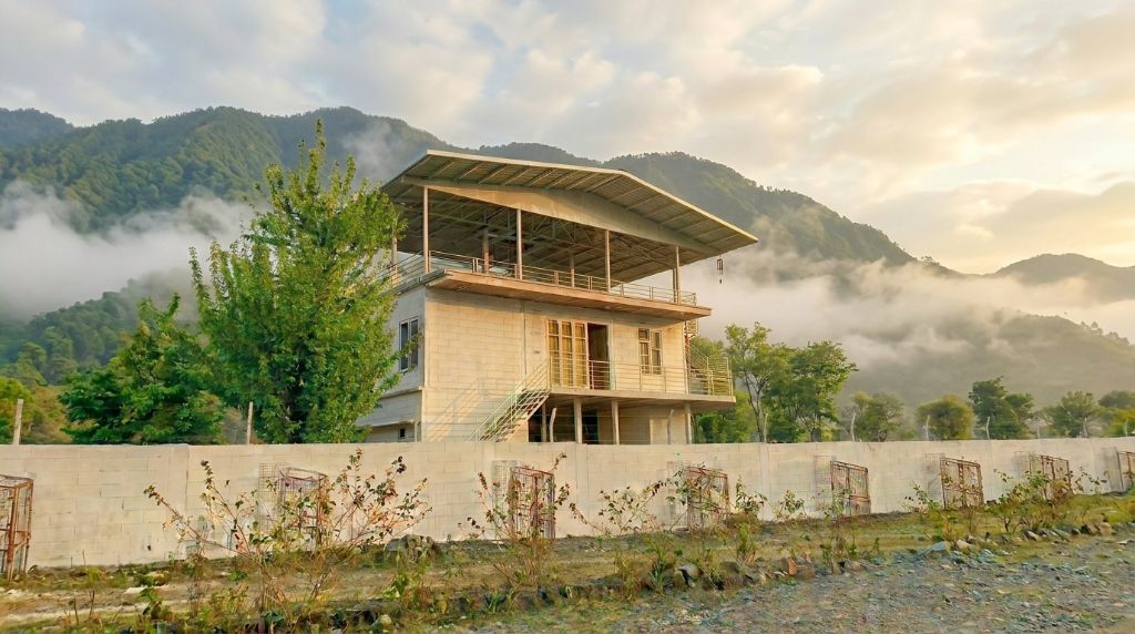 Yellow Bird Farmhouse exterior with open terrace and mountain skies